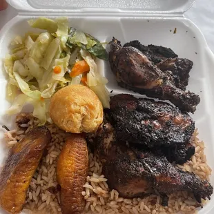 Jerk chicken, rice and peas, cabbage.