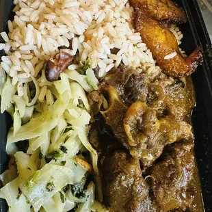 Oxtails Rice &amp; Peas along with cabbage