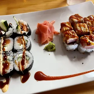 a plate of sushi with sauce and sauce