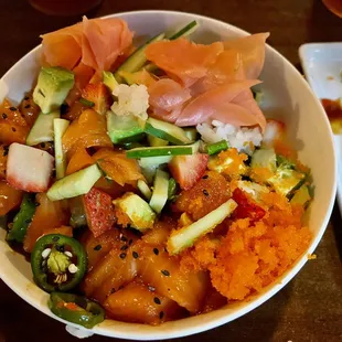 Salmon Poke bowl with added strawberries, masago, and Serrano peppers