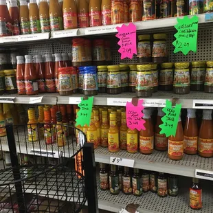 a grocery store shelf full of sauces and condiments