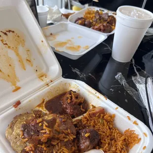 a tray of rice with meat and beans