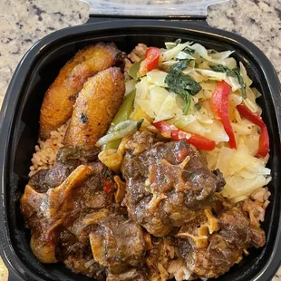 Oxtails with Sweet and Fried Slices of Plantains and cabbage