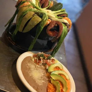 Molcajete para Dos: 
This Authentic dish (for 2) comes in a hot stone bowl; carne asada, grilled chicken, grilled shrimp, sausage, grilled