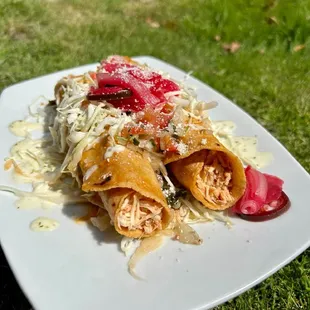 Crispy Honduran Tacos:
Chicken taquitos, cabbage slaw, secret house dressings and pickled red onions