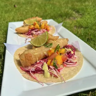 Beer battered tilapia strips, citrus slaw, arugula, cilantro crema. (2)