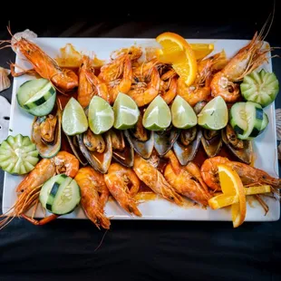 a platter of grilled shrimp and cucumbers