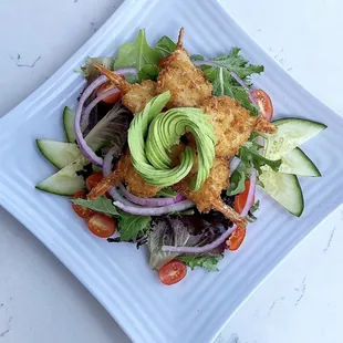 Caribella salad topped off with our coconut shrimp.