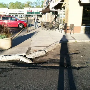 Broken curb, low pavement holds rain etc, ala lake caribou