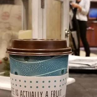 a coffee cup with a quote on it