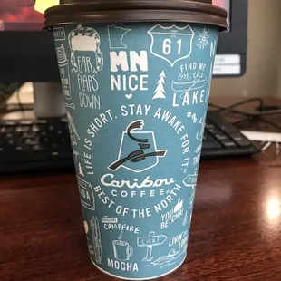 a cup of coffee on a desk