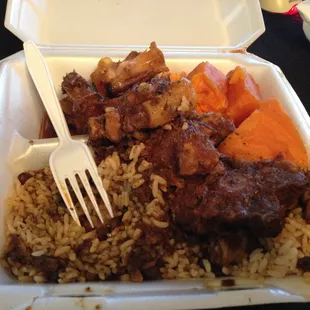 Stewed ox tail with a bed of rice and peas and huge pieces of sweet potatoes