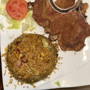 a plate of food with meat, rice and vegetables