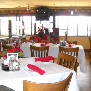 tables and chairs with red napkins