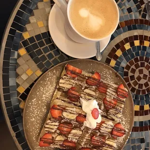 Large latte with waffles; strawberry, banana and nutella topping.