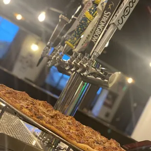 a pizza and beer taps