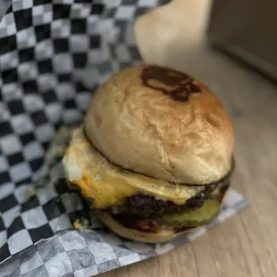 cheeseburger in checkered wrapper