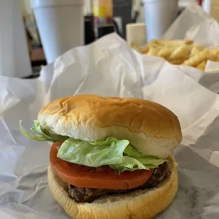 Hamburger with lettuce, tomato, Mayo, and pickles.