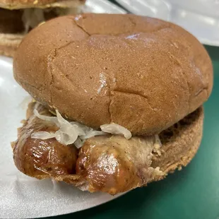 Bratwurst sandwich on wheat bun.