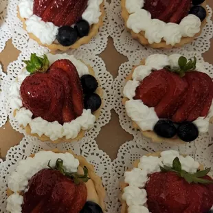 Strawberry tartlets: fresh strawberries, on a bed of pastry cream, with a sweet crust, and made from scratch whipped topping.