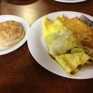 Philly cheesesteak omelette with hash browns and a biscuit.