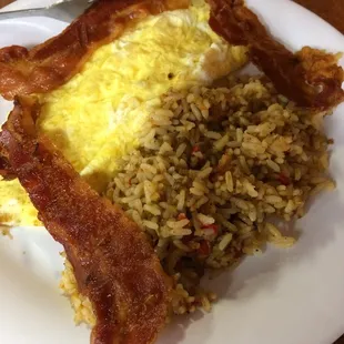 Scrambled eggs, bacon, and breakfast rice.
