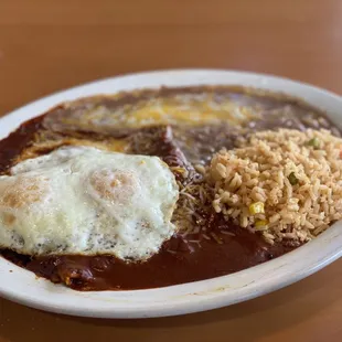 Eggs on cheese enchiladas beans and rice