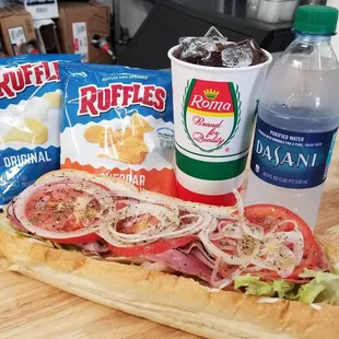 a sub sandwich, chips, and soda