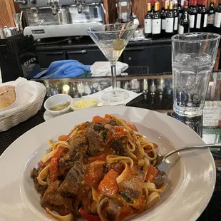 a plate of pasta with meat and vegetables