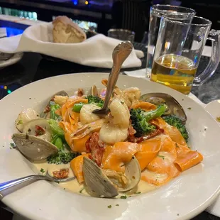 a plate of seafood and broccoli