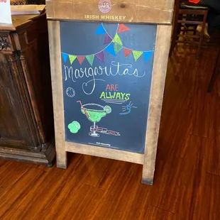 a chalkboard sign in a restaurant