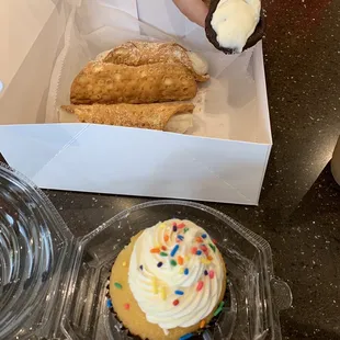 Cannolis (save five dollars when you buy four regular cannolis and one chocolate chip cannoli) and a cupcake