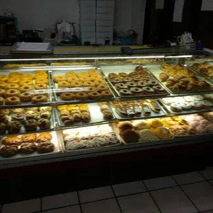 a variety of pastries in a display case