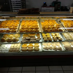 a variety of baked goods in a display case