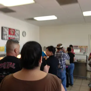 a group of people standing in a kitchen