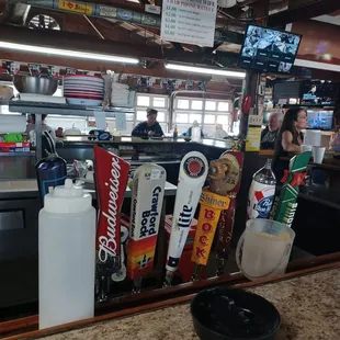 a bar counter with a variety of beer taps