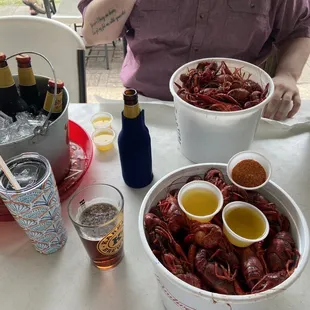 a bowl of craws and bottles of beer