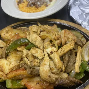 Sizzlin Fajitas . With chicken , steak and shrimp . Order your way , we are happy to serve you