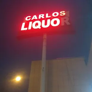 a neon sign for carlos liquor