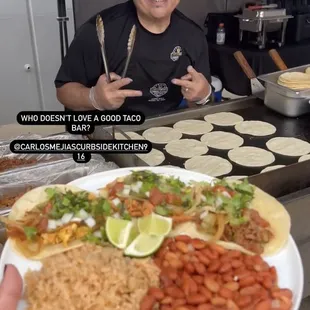 Carlos serving up Dem Tacos