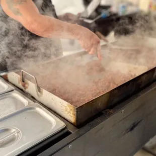 Carlos cooking that delicious Pork al Pastor