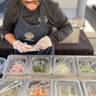 Patricia setting up a topping bar. All traditional toppings. No lettuce, cheese or diced tomatoes! That would be Taco Bell! Lol