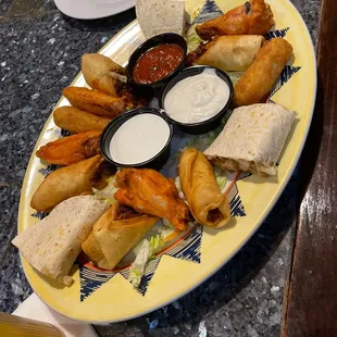 a plate of appetizers and dips
