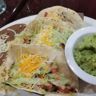 a plate of tacos and guacamole
