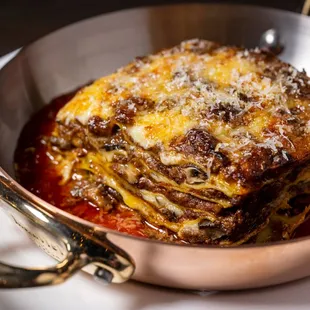 a plate of lasagna with sauce and cheese