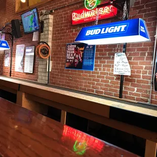 a brick wall with neon signs