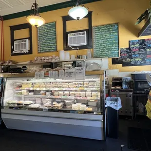 Current menus on the wall, case with carryout deli offerings