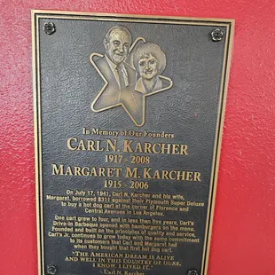 a plaque on a red wall