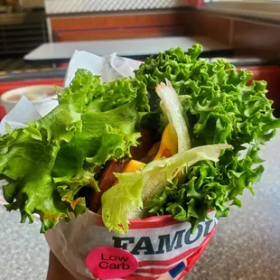 Lettuce wrapped famous star w/ extra cheese, raw onion, grilled onion, tomato and pickles