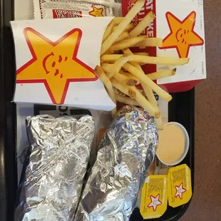 a tray of food including french fries, chips, and sauce